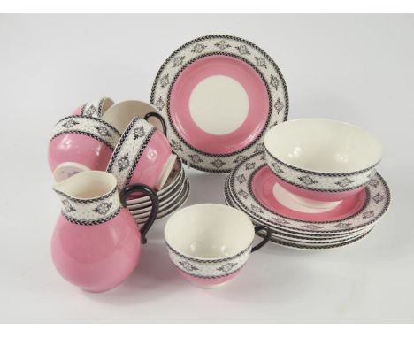 A Royal Worcester porcelain part tea service, circa 1918, decorated in black with flowers against a pink ground, comprising c