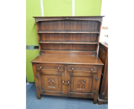 A Webber of Croydon oak dresser, mid 20thC, the two shelf delft rack, above two drawers and cupboards, raised on straight leg