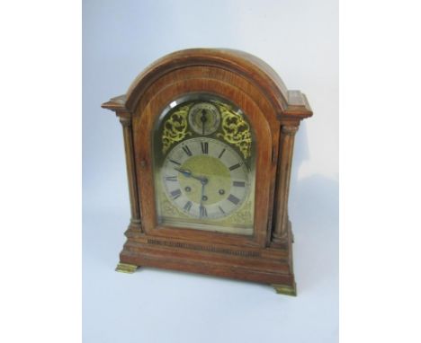 A Gustav Becker oak cased table clock, of architectural form, brass dial with foliate spandrels, silvered chapter ring bearin