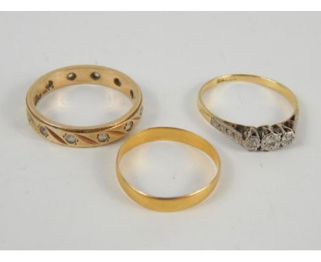 A 22ct gold wedding band, size M, 1.4g, 9ct gold and zircon eternity band, size R, 3.5g, and a yellow metal, platinum and dia