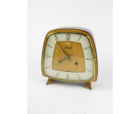 A Hermle 1950's ebonised and pale wood cased mantel clock, shaped dial, eight day movement, 18.5cm x 7.5cm x 19cm.