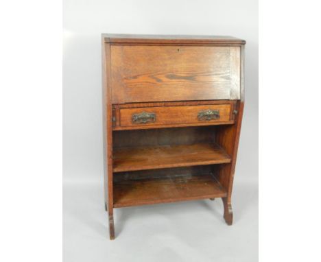 A Victorian oak student's bureau, the fall flap opening to reveal recesses, over a frieze drawer above two open shelves raise