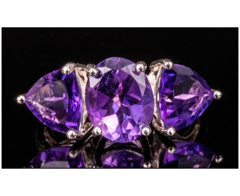 Amethyst Three Stone Ring, the central oval stone being 2.3cts, the trillion cuts to either side being 1.6cts each, the total