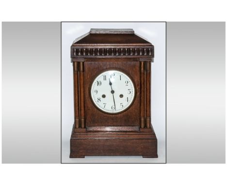 German / Austrian 19th Century Oak Cased Mantel Clock with Eight Day Striking and Chiming Movement on 4 Gongs. Porcelain Whit