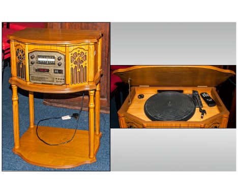 Reproduction Electric Record Player In a Bleached Oak Case With a Shaped Front Console Supported on Round Fluted Legs. 22 Inc