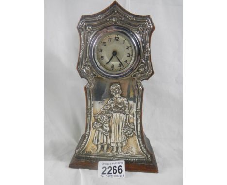 A silver framed mantel clock in good condition, 9" tall