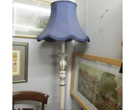 A painted standard lamp with shade.
