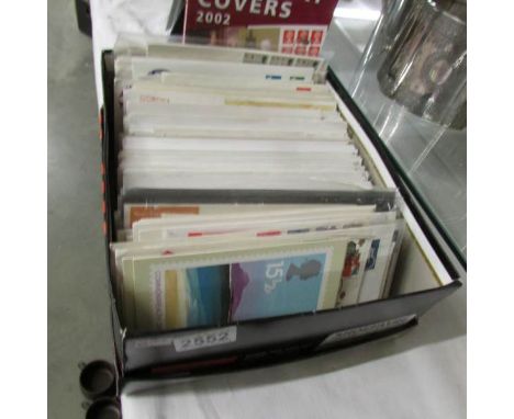 A box of assorted first day covers and a 2002 Brabury first day cover catalogue.