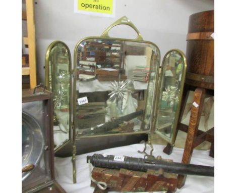 A triple brass firescreen with star cut mirrors.