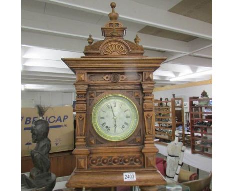 A late Victorian tall oak mantel/bracket clock with silvered dial, in very good condition. 28" tall.In good working order.The