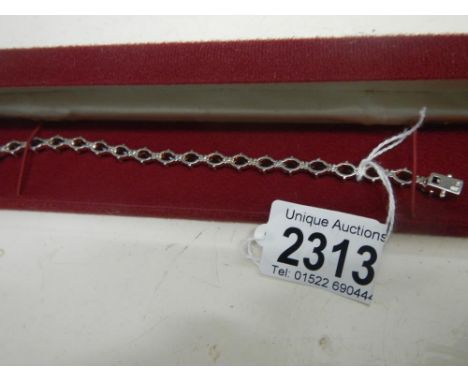 A rich red garnet set bracelet with 20 garnets, approximately 10 carats, in a silver setting, stamped and with safety clasp.