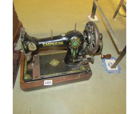 A vintage Empress sewing machine (no cover).