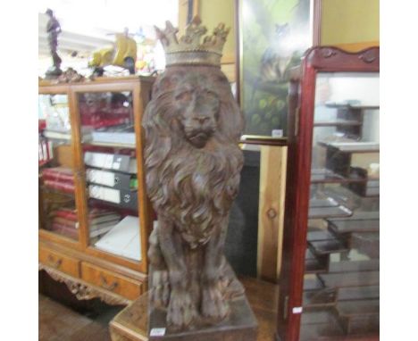 A garden figure of a lion wearing a crown.