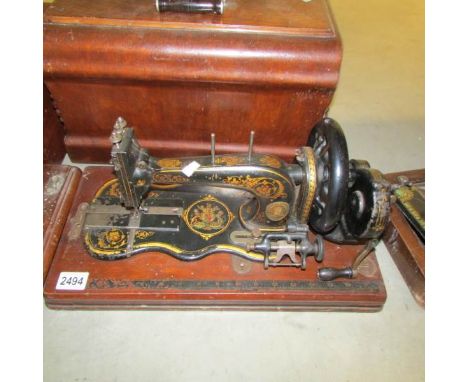 A vintage sewing machine with cover.