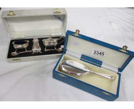 A boxed silver plate cruet set and a boxed silver plate brush.