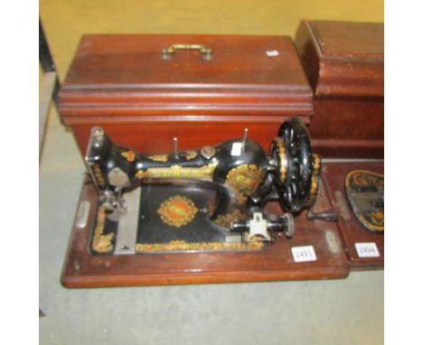 A vintage Jones sewing machine with cover.