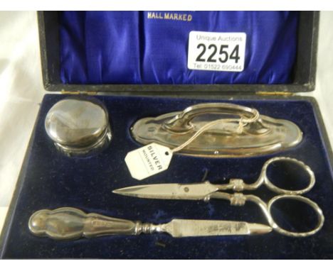 A silver manicure set.The scissors are not the correct ones for the set.