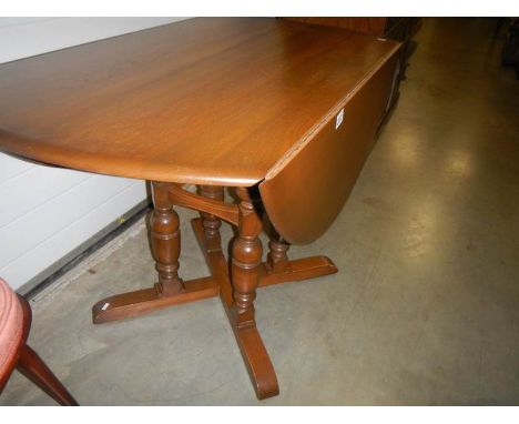 A good quality 4 pillar Ercol style drop leaf table.