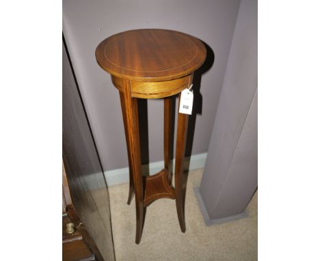 A mahogany Edwardian plant stand with line inlay, raised on square tapered legs and shelf under.