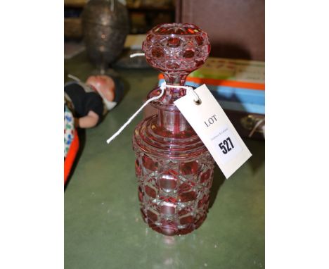 A 19th Century cut glass hob-nail pattern cylindrical decanter with ruby overlay and matching stopper. 