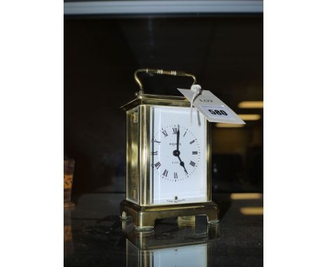 A modern four glass carriage clock, with bevelled glass panels in brass framed case, the white enamel dial with roman numeral