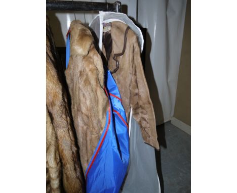 A lady's light coloured three-quarter length fur jacket with black lining; and a lady's leather coat with brown leather butto