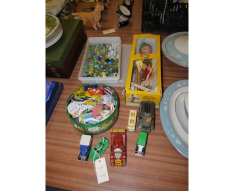 A Pelham puppet; a collection of glass marbles; a tin full of badges; and six toy vehicles, various.
