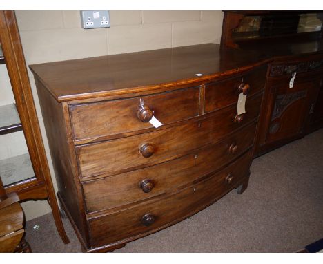 A 19th Century mahogany bowfront chest of drawers, inlaid edge of two short and three long graduating drawers, with turned ha