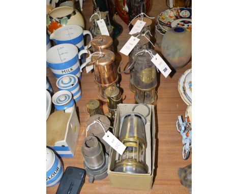 A collection of miner's lamps, including: three type SL's by The Protector Lamp & Lighting Company; a pair of copper safety l
