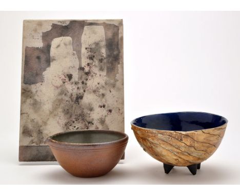 A pottery bowl, with blue glaze interior, sgrafitto style wave pattern decoration to exterior, on four conical feet, 17.5cms 