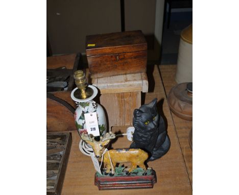 An Oriental ware table lamp; two modern cast iron door stops; a wooden stool; and a small 19th Century mahogany tea caddy.