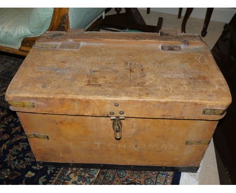 A leather trunk with metal mounts.