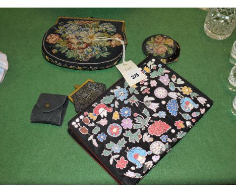 A lady's embroidered clutch bag; powder compact; tapestry clutch bag; small purse; and a scent bottle in black material conta