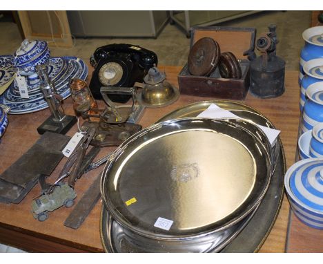 A collection of plated salvers; brass postal balance on wooden base; a black finger dial telephone hand set; a brass paraffin