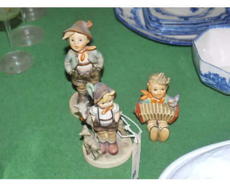 Three Hummel figures.