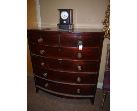 A 19th Century mahogany bowfront chest of two short and four long drawers with original ornate brass handles, raised on brack