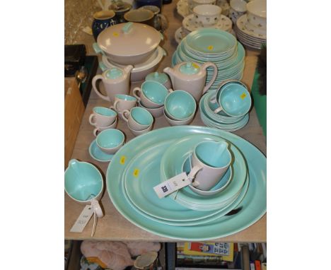 A Poole ware part dinner, tea and coffee service in turquoise and pink.