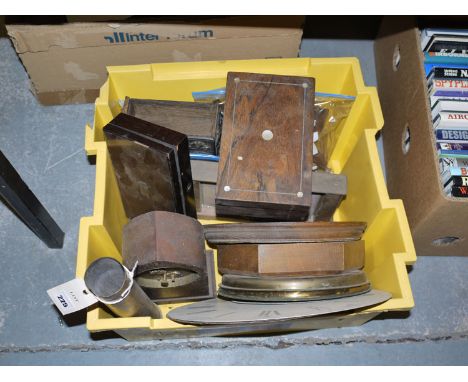 A collection of clock and barometer cases; two rosewood boxes; a WWII brass shell case; and sundries.
