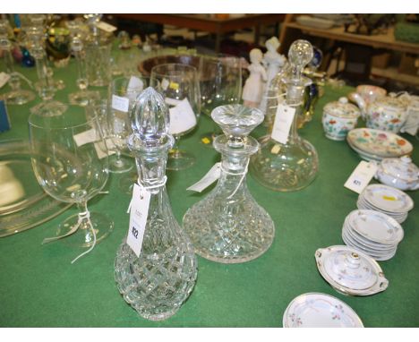A ship's style cut glass decanter and stopper; and two other decanters.