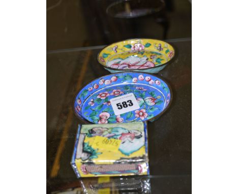 Two oval enamel small dishes, one in yellow and the other in blue, both with Oriental foliage design; and a matching matchbox