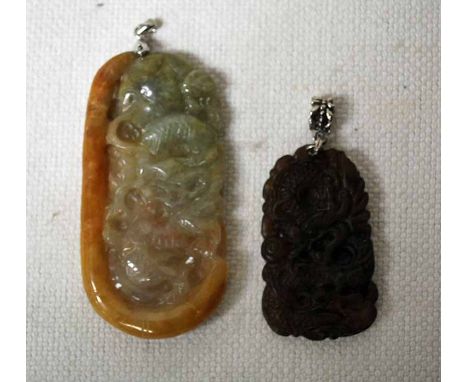 An Oriental carved Jade Pendant, decorated in relief with mythical creatures, rounded rectangular form, 66mm long by 34mm wid