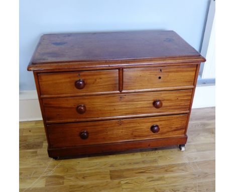 A late Victorian mahogany chest of drawers having two short over three long drawers raised on ceramic castors, 106 x 79cm