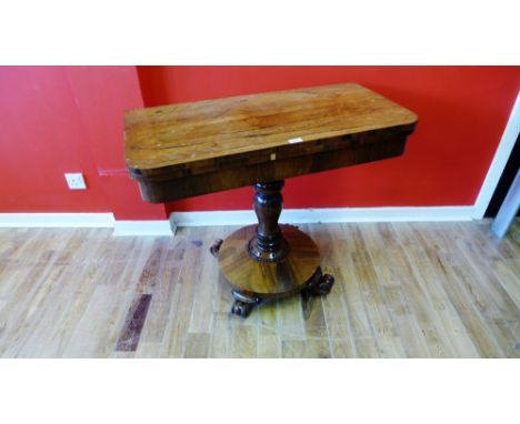 A late Victorian mahogany flip top card table, having a moulded top, raised on turned pedestal supports and moulded feet, 92 