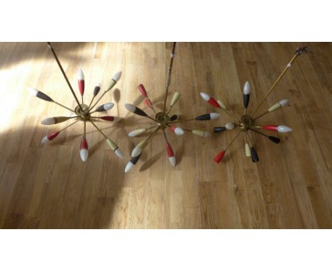 Three vintage Sputnik style ceiling light pendants, the brass arms with red, white and black terminals, complete with a box o