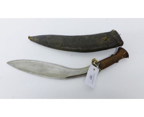 A Kukri style knife with leather scabbard 