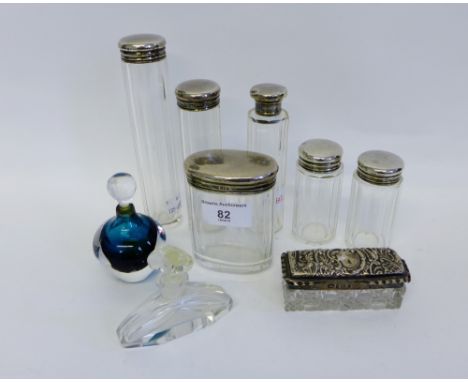A group of six Edwardian London silver topped and glass toilet bottle together with a Birmingham silver topped and cut glass 