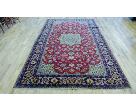 Tabriz carpet, the red field with central flowerhead medallion and foliate borders and spandrels, 355 x 225cm 