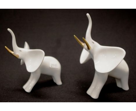 Two Hollohaza Hungary ceramic elephant figures a graduated pair, each standing elephant with trunk raised, marked to bases, (