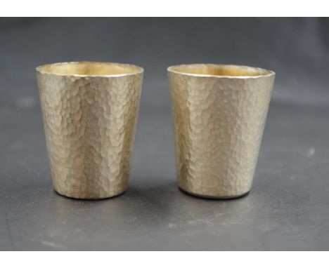 Two Australian hammered silver nip cups marked 925, dedication inscribed 1993 to base of cup, 4.5cm high, 75 grams approx