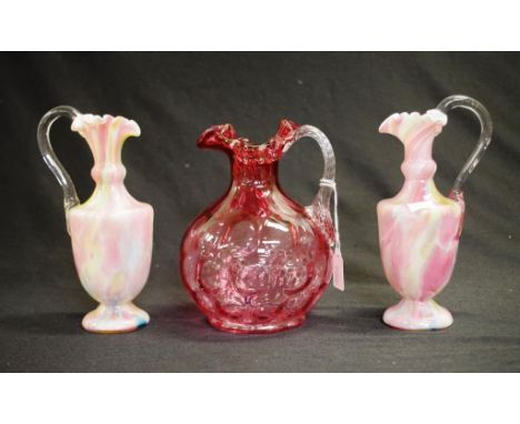 Three vintage decorative glass jugs including: good ruby glass water jug, (height 17cm approx); and a pair pink glass ewers, 